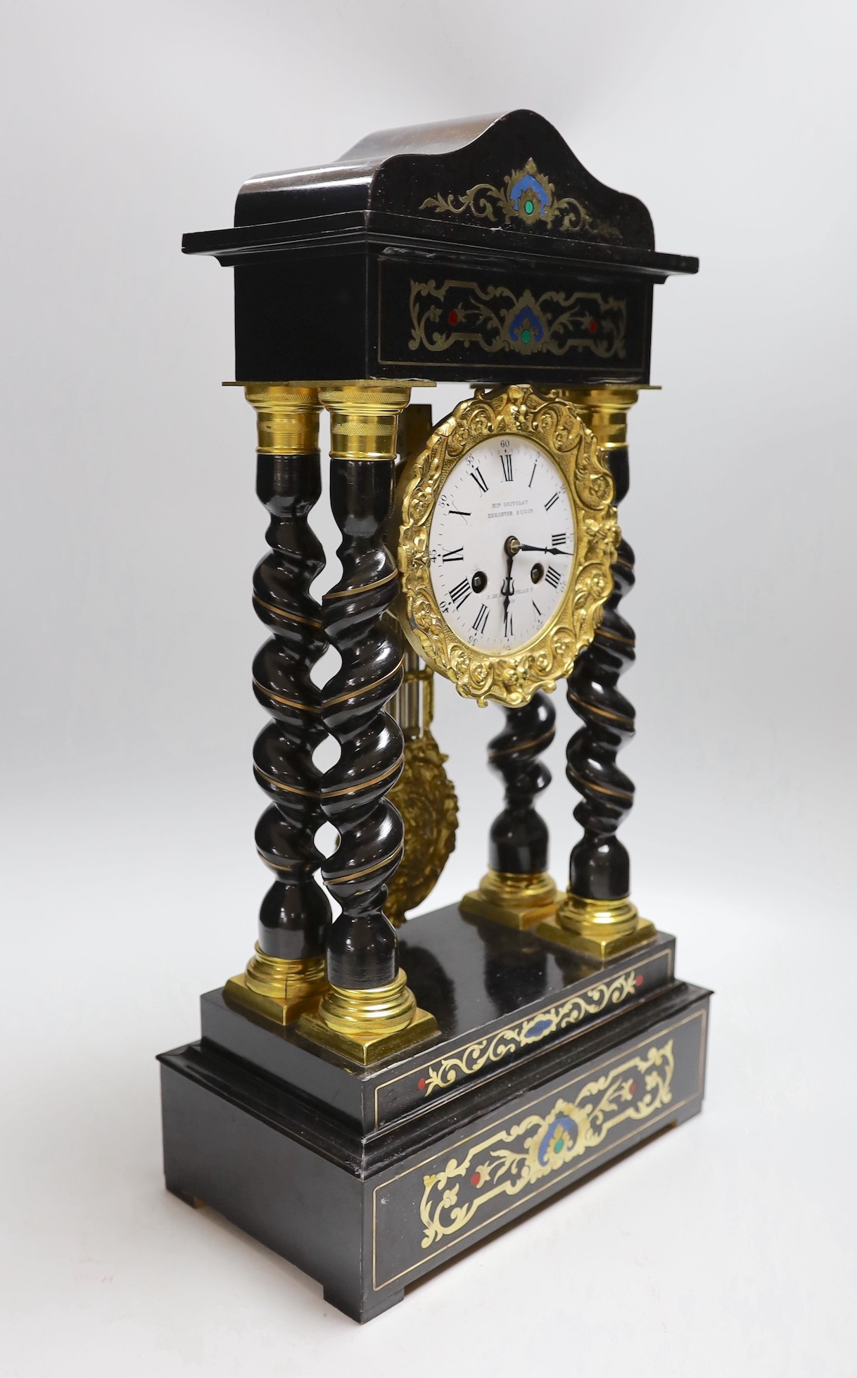 A French Napoleon III ebonised and brass inlaid portico clock. 49cm tall
